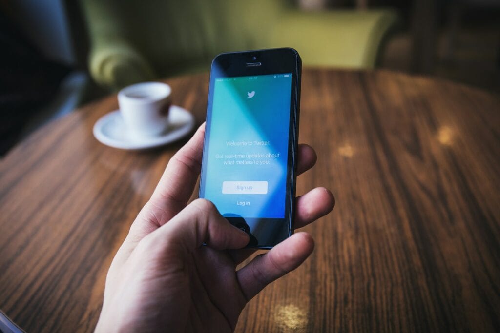 woocommerce vs magento person holding turned on space gray iPhone 5c near table