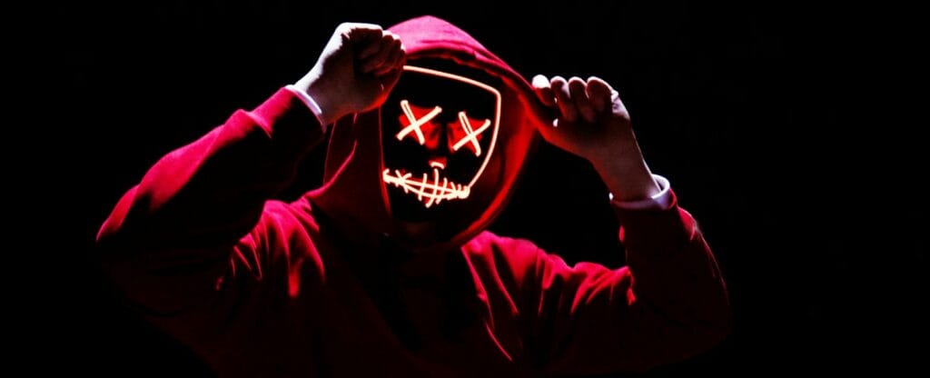 woocommerce vs magento a person wearing a mask with a creepy face